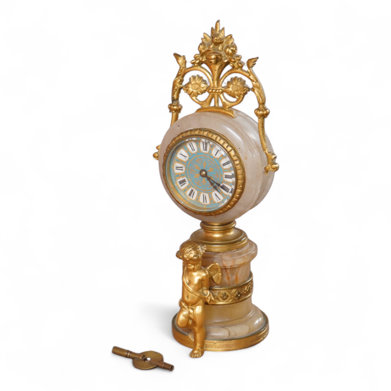 A late 19th century French ormolu and alabaster timepiece with painted dial and key, 24cm high